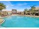 Resort-style pool featuring lounge chairs, palm trees, and views of the building's exterior at 7663 Recife Dr, Kissimmee, FL 34747