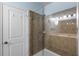 Bathroom with a large glass shower featuring stylish tile and modern fixtures, and a glass door at 8807 Tatara St, Orlando, FL 32836