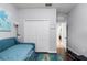 Bedroom featuring hardwood floors, a daybed, a closet with folding doors, and access to an ensuite bathroom at 8807 Tatara St, Orlando, FL 32836
