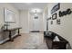 Inviting foyer with tile flooring, a decorative rug, and a wooden console table with a lamp and mirror at 8807 Tatara St, Orlando, FL 32836
