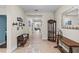 Inviting foyer with tile flooring, a decorative rug, and a wooden console table with a lamp and mirror at 8807 Tatara St, Orlando, FL 32836