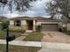 Charming single-story home with brick driveway, attached garage, and manicured landscaping at 8807 Tatara St, Orlando, FL 32836