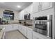 Updated kitchen featuring granite countertops, white cabinets and stainless steel appliances at 8807 Tatara St, Orlando, FL 32836