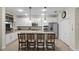Modern kitchen featuring white cabinets, stainless steel appliances, and a breakfast bar at 8807 Tatara St, Orlando, FL 32836