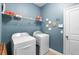 Functional laundry room with washer, dryer, and storage shelf at 8807 Tatara St, Orlando, FL 32836