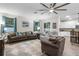 Open-concept living area with tile floors, comfortable seating, and access to the kitchen at 8807 Tatara St, Orlando, FL 32836