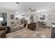 Spacious living area adjacent to dining and kitchen, featuring neutral decor and tile flooring at 8807 Tatara St, Orlando, FL 32836