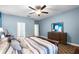 Bedroom with a large bed, stylish furniture, and access to a well-lit en-suite bathroom at 8807 Tatara St, Orlando, FL 32836