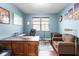 Home office with wood floors, neutral paint and comfortable furniture at 8807 Tatara St, Orlando, FL 32836