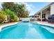 Lush landscaping surrounds the beautiful pool and spa, accompanied by an outdoor dining area and patio for entertaining and relaxing at 8807 Tatara St, Orlando, FL 32836