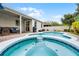 Stunning view of a backyard pool and patio with ample seating and lush landscaping, perfect for entertaining and relaxation at 8807 Tatara St, Orlando, FL 32836