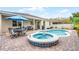 Beautiful backyard pool and patio area with a spa, ample seating, and a covered porch, ideal for outdoor living and entertaining at 8807 Tatara St, Orlando, FL 32836