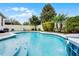 Beautiful backyard pool and spa area with a waterfall feature, lush landscaping, and a paver deck, perfect for relaxation at 8807 Tatara St, Orlando, FL 32836