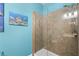 The tiled walk-in shower features a clear glass door and modern shower head at 8807 Tatara St, Orlando, FL 32836