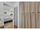 Bathroom leads to the bedroom, featuring a striped shower curtain and modern fixtures at 10 Pine Course Pass, Ocala, FL 34472