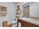 Well-lit bathroom with wood accents, shelves for storage, and neutral decor at 10 Pine Course Pass, Ocala, FL 34472