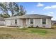 Charming single-story home with manicured lawn, a front-facing garage and inviting front porch at 10 Pine Course Pass, Ocala, FL 34472