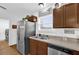 A kitchen area with stainless steel appliances, wooden cabinets, a window, and decor at 10 Pine Course Pass, Ocala, FL 34472