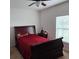 A carpeted main bedroom features an accent wall and a window overlooking the lush backyard at 1107 Galway Blvd, Apopka, FL 32703