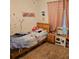 Cozy bedroom with carpet flooring, a light wood bed frame, and pink curtains covering the window at 1107 Galway Blvd, Apopka, FL 32703