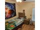 bedroom featuring carpet flooring, a decorative space-themed wall tapestry, and a window with blinds at 1107 Galway Blvd, Apopka, FL 32703