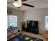 Living room with two windows and a ceiling fan with a solar system rug on the floor at 1107 Galway Blvd, Apopka, FL 32703