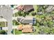 An aerial view showcases homes with screened pools, well-kept lawns, and proximity to lush, mature trees at 11278 Papyrus Ln, Orlando, FL 32821