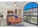 Bright breakfast nook with barstool seating and an arched window providing views to the outdoors at 11278 Papyrus Ln, Orlando, FL 32821