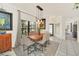 Dining room featuring a wooden table and elegant lighting, with a view to the entryway at 11278 Papyrus Ln, Orlando, FL 32821