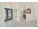 Bright foyer with an arched doorway leading to the kitchen and decorative mirror at 11278 Papyrus Ln, Orlando, FL 32821