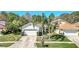 Inviting home with a two-car garage, neatly kept lawn, and beautiful, mature palm trees at 11278 Papyrus Ln, Orlando, FL 32821