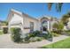 Stucco home featuring a large arched window, lush landscaping, and a serene fountain at 11278 Papyrus Ln, Orlando, FL 32821