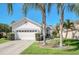 Charming single-story home with a well-manicured lawn and mature palm trees at 11278 Papyrus Ln, Orlando, FL 32821