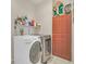 Laundry room features washer, dryer, storage and shelving at 11278 Papyrus Ln, Orlando, FL 32821