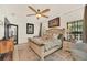 Bright and airy main bedroom with a ceiling fan, neutral decor, and large bed at 11278 Papyrus Ln, Orlando, FL 32821