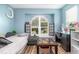 Bright bedroom featuring a large arched window, wood floors, and a cozy atmosphere at 12100 Calaboose Ct, Orlando, FL 32828