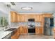 Modern kitchen featuring stainless steel appliances, sleek countertops, and ample cabinet space, perfect for cooking and entertaining at 12100 Calaboose Ct, Orlando, FL 32828