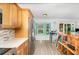 Modern kitchen featuring stainless steel appliances and an adjacent breakfast nook with views of the backyard pool area at 12100 Calaboose Ct, Orlando, FL 32828