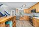 Bright kitchen featuring stainless steel appliances, custom wood cabinets, mosaic backsplash and a stainless steel farmhouse sink at 12100 Calaboose Ct, Orlando, FL 32828