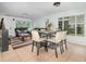 Open-concept living area with dining table and sitting area, showcasing bright natural light and seamless flow at 12100 Calaboose Ct, Orlando, FL 32828