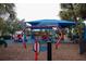 Colorful community playground with sunshade for outdoor fun and recreation at 12100 Calaboose Ct, Orlando, FL 32828