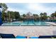 A luxurious community pool with comfortable lounge chairs and verdant landscaping for resort-style living at 12100 Calaboose Ct, Orlando, FL 32828