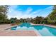 Community pool with lounge chairs and seating area, set in a tropical landscape at 1211 Stonecutter Dr # 304, Celebration, FL 34747