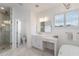 Bright bathroom features a modern tub, marble floors, and lots of natural light at 1230 Mercedes Pl, Orlando, FL 32804