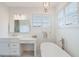 Bright bathroom features a modern tub, marble floors, and lots of natural light at 1230 Mercedes Pl, Orlando, FL 32804