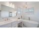 Bright bathroom features a modern tub, marble floors, and lots of natural light at 1230 Mercedes Pl, Orlando, FL 32804