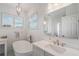 Bright bathroom features a modern tub, marble floors, and lots of natural light at 1230 Mercedes Pl, Orlando, FL 32804