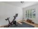 Exercise room with natural light, stationary bike, wood floors and exercise mat at 1230 Mercedes Pl, Orlando, FL 32804