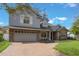 Charming two-story home with stone accents, a brick driveway, and a well-manicured lawn at 1230 Mercedes Pl, Orlando, FL 32804