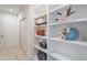 Hallway with built in white shelving with books and decorations at 1230 Mercedes Pl, Orlando, FL 32804